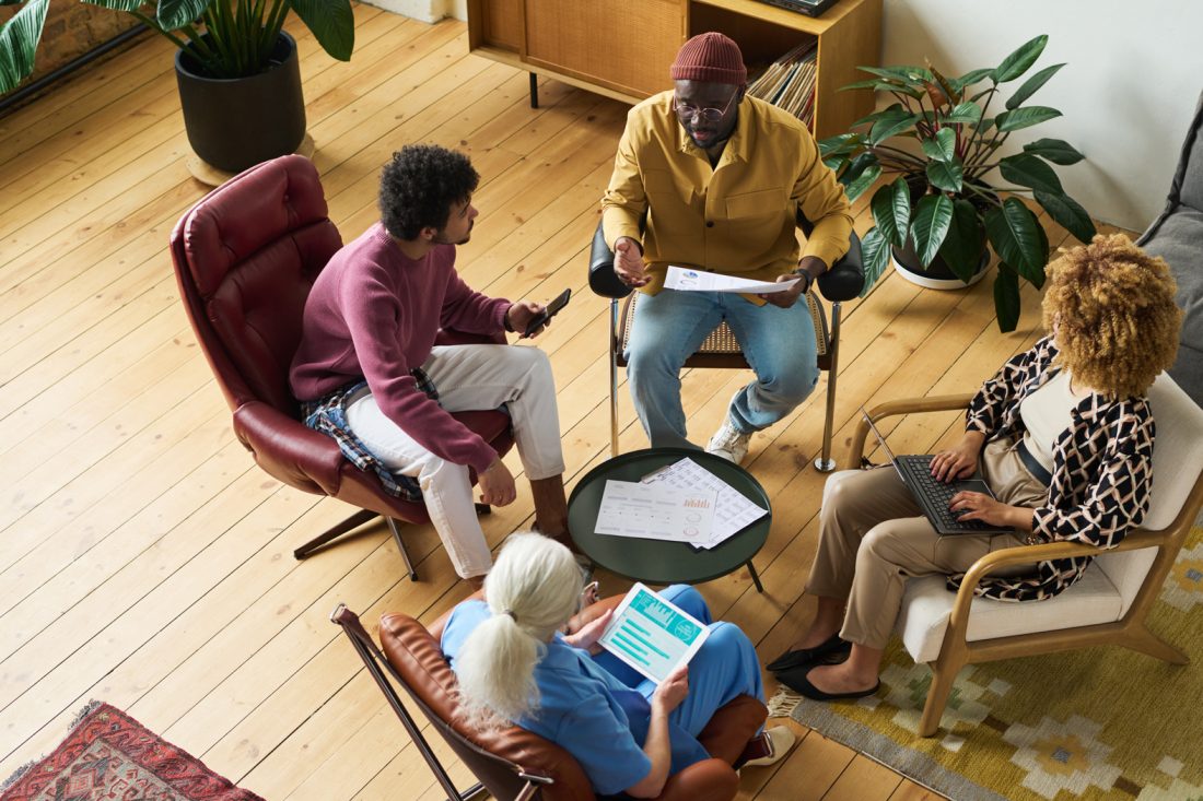 Above Angle Of Intercultural Coworkers Gathered In Office For Discussion