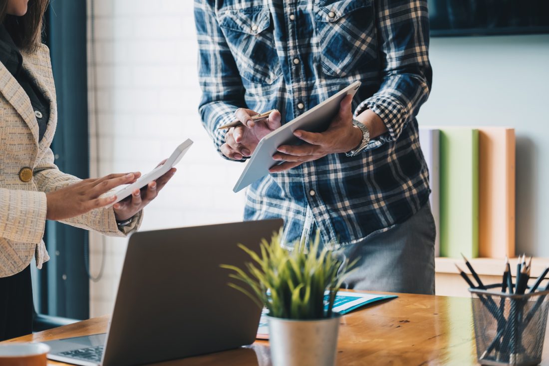 Business People Meeting To Discuss The Situation On The Market With Tablet Computer