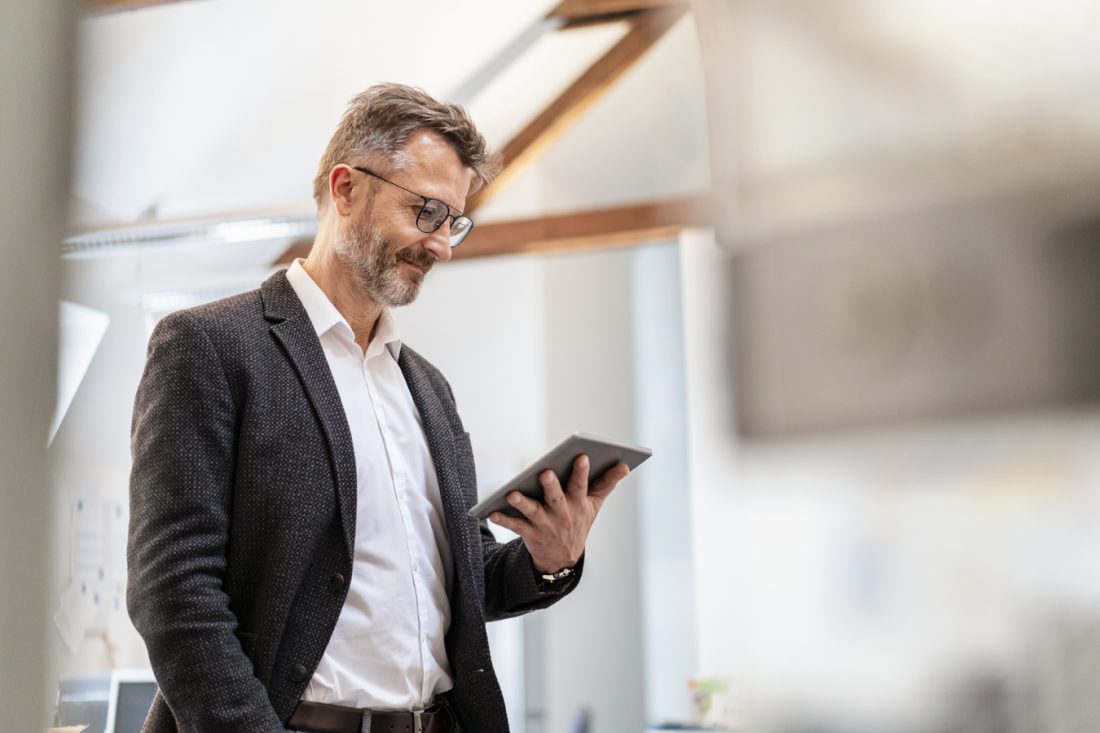 Businessman Using Tablet In Office