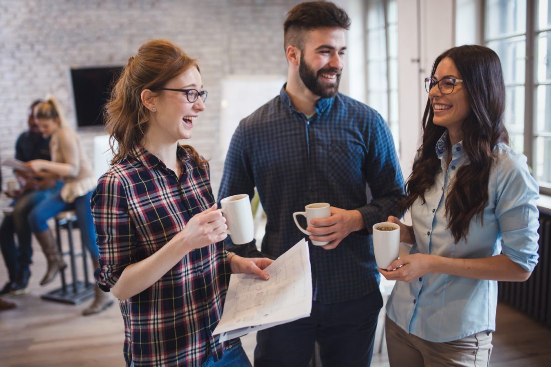 Coworking Colleagues Having Conversation At Workplace